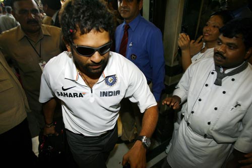 Sachin Tendulkar (L) is welcomed by enthusiastic staff upon his arrival at a hotel in New Delhi on March 6, 2008. One-day international captain Mahendra Singh Dhoni has led his team back home after India wrapped up the triangular competition when they beat Australia in Brisbane by nine runs to take an unbeatable 2-0 lead in the best-of-three finals series on March 4. The champions are back