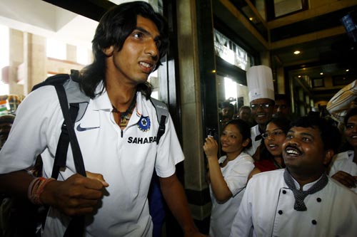 Ishant Sharma (L) is welcomed by enthusiastic staff upon his arrival at a hotel in New Delhi on March 6, 2008. Mahendra Singh Dhoni has led his team back home after India wrapped up the triangular competition when they beat Australia in Brisbane by nine runs to take an unbeatable 2-0 lead in the best-of-three finals series on March 4. The champions are back