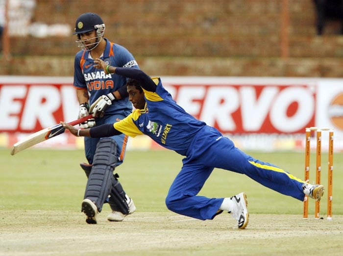 Sri Lankan bowler Ajantha Mendis dives for the ball unsuccessfully as Indian batsman vice captain Virat Kohli fails to take a run in the second match of the Micromax Cup Triangular One-Day International series at Queens Sports club in Bulawayo . (AFP Photo) 2nd ODI: Ind vs Zim