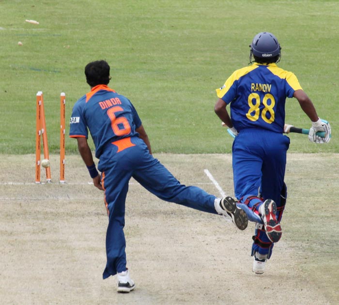 Indian bowler, Ashok Dinda, left, takes a shy at the stumps to run out Sri lankan batsman Suraj Randiv, right, during a match against India at Queens Sports Club in Bulawayo, Zimbabwe. (AP Photo) 2nd ODI: Ind vs Zim