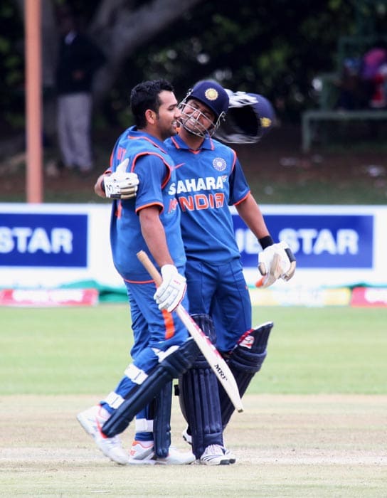 Indian skipper Suresh Raina celebrates with Rohit Sharma after India beat Sri Lanka by 7 wickets in the second match of the Micromax Cup Triangular One-Day International series at Queens Sports club in Bulawayo . (AP Photo) 2nd ODI: Ind vs Zim