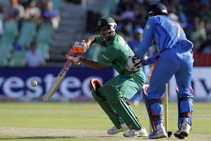South Africa's batsman Jean-Paul Duminy, plays a side shot as India's captain Mahendra Singh Dhoni looks on during the first One Day International between India and South Africa at Kingsmead Stadium in Durban. (AP Photo) 1st ODI: Ind vs SA