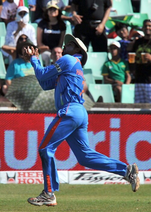 Indian Harbhajan Singh catches out South Africa's Hashim Amla for 50 runs during the first One Day International between India and South Africa at Kingsmead Stadium in Durban. (AFP Photo) 1st ODI: Ind vs SA