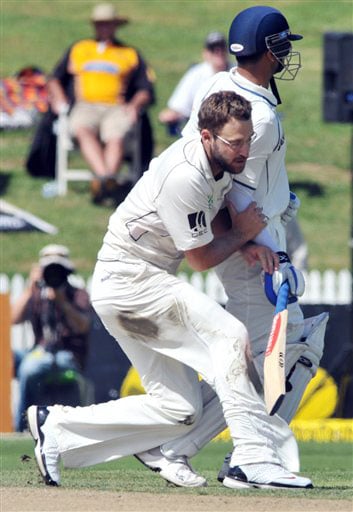 Daniel Vettori runs into Rahul Dravid on the second day of the first Test in Hamilton, New Zealand. (AP Photo) India vs NZ: 1st Test, Day 2