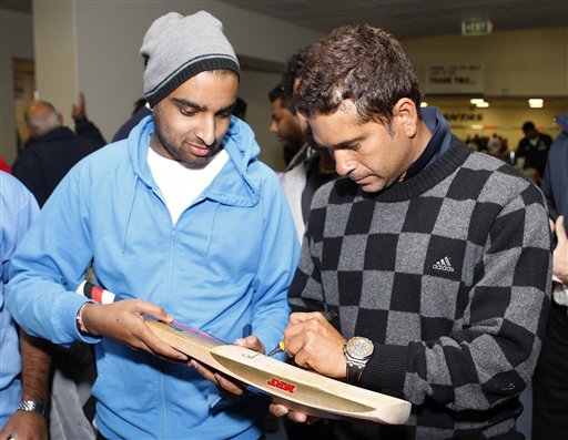Sachin Tendulkar, right, signs his autograph on his arrival at Christchurch airport on Friday, February 20, 2009. India will play three Test matches, five one-day internationals and two twenty20 matches during the cricket tour of New Zealand. (AP Photo) India arrive in New Zealand