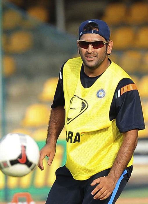 Indian cricket team captain Mahendra Singh Dhoni plays with a ball during a training session at the Rangiri Dambulla International Cricket stadium in Dambulla. India meet Pakistan on June 19 for the fourth One Day International cricket match of the Asia Cup.(AFP PHOTO) India, Pakistan gear up for big clash