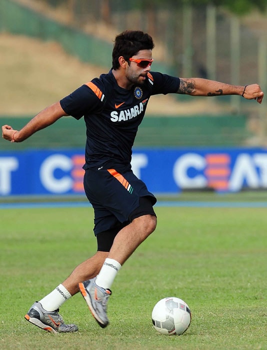 Indian cricketer Virat Kohli plays football during a training session in Dambulla. (AFP PHOTO) India, Pakistan gear up for big clash