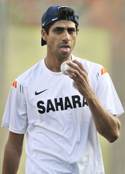 Ashish Nehra prepares to lick the ball during a practice session in the nets in Dhaka. (AP Photo) India sweat on Bangla soil