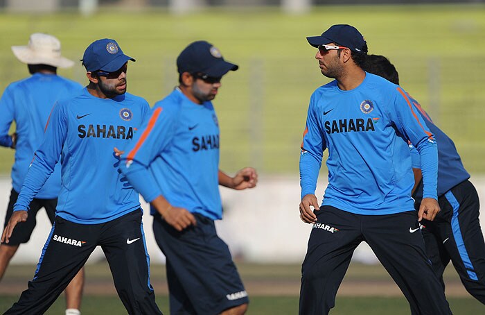 Yuvraj Singh stretches with his teammates during a practice session at the Sher-e Bangla National Stadium in Dhaka. (AFP Photo) India sweat on Bangla soil