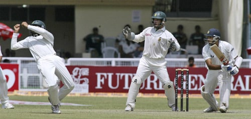 VVS Laxman, right, takes a shot as South Africa's Hashim Amla, left, and wicketkeeper Mark Boucher react during the second day of the third Test cricket match of the Future Cup series in Kanpur on Saturday, April 12, 2008. Kanpur Test, Day 2