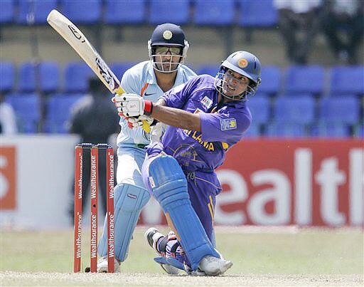 Kumar Sangakkara plays a shot as Mahendra Singh Dhoni looks on during the fifth and final ODI of the five-match series between India and Sri Lanka in Colombo. 5th ODI: India vs Sri Lanka
