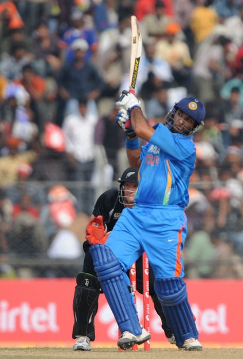 India's Yuvraj Singh (R) plays a shot watched by New Zealand's Gareth Hopkins (back L) during the first one-day International cricket match against New Zealand at Nehru Stadium in Guwahati. (AFP Photo) 1st ODI: Ind v NZ