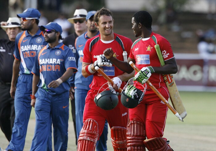 Zimbabwean captain Elton Chigumbura (R) and team mate Craig Ervine walk off the field after winning the match against India by six wickets in the first match of the Micromax Cup Triangular One day International. (AFP Photo) 1st ODI: Ind vs Zim