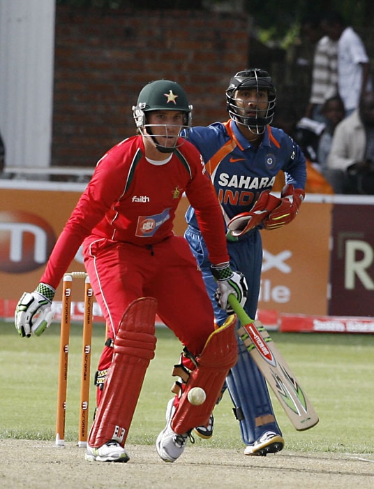 Zimbabwean Batsman Brendan Taylor defends the ball as Indian wicket keeper Dinesh Karthik looks on. (AFP Photo) 1st ODI: Ind vs Zim