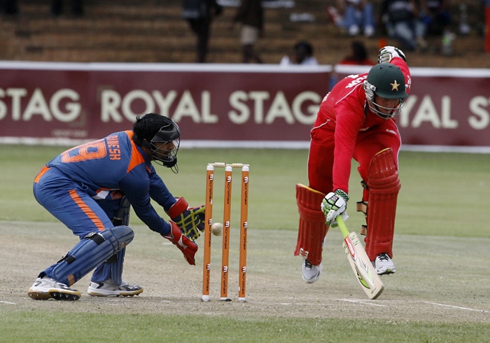 Zimbabwean Batsman Brendan Taylor completes a run as Indian wicket keeper Dinesh Karthik tries unsuccessfully to run him out. (AFP Photo) 1st ODI: Ind vs Zim