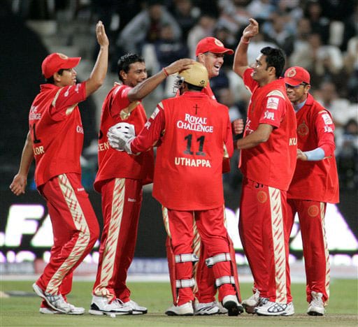 Bangalore Royal Challengers team members react after taking the wicket of Rajasthan Royals Shane Warne during the Indian Premier League Twenty20 match in Cape Town. (AP Photo) Match 2: JAI vs BLR