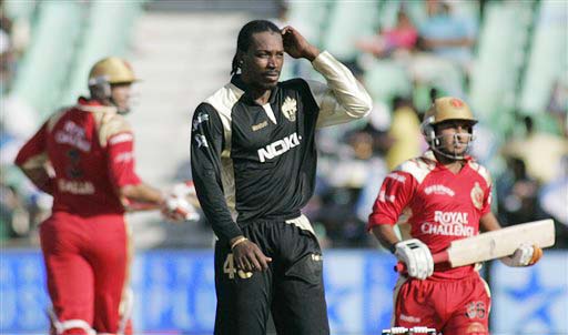 Kolkata Knight Riders' Chris Gayle reacts as Royal Challengers Bangalore players run during their IPL match in Durban on Wednesday. (AP Photo) Match 19: BLR vs KOL
