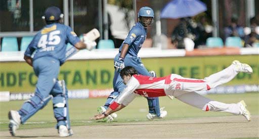 Kings XI Punjab's S Sreesanth dives to stop the ball as Deccan Chargers' Tirumalasetti Suman and Rohit Sharma watch during their IPL match in Kimberley on Saturday. (AP Photo) Match 36: HYD vs MOH