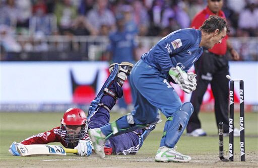 Dinesh Karthik successfully completes his run, as wicketkeeper Adam Gilchrist attempts to run him out, during their IPL match in Durban. (AP Photo) Match 43: DEL vs HYD