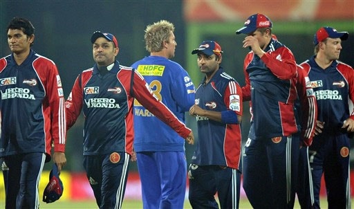 Rajasthan Royals' Shane Warne walks past Virender Sehwag as he congratules Delhi Daredevils at the end of their IPL match in Bloemfontein. (AFP Photo) Match 50: DEL vs JAI