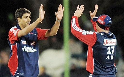 Ashish Nehra celebrates with teammate AB de Villiers after taking the wicket of Graeme Smith during their IPL match in Bloemfontein. (AFP Photo) Match 50: DEL vs JAI