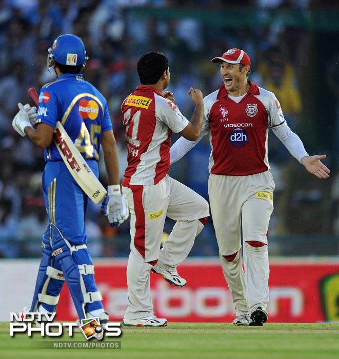 Piyush Chawla celebrates the wickets of Dinesh Karthik with David Hussey during the IPL Twenty20 match between Kings XI Punjab and Mumbai Indians at PCA Stadium in Mohali. (AFP Photo) IPL 5: Mumbai beat Punjab by 4 wickets