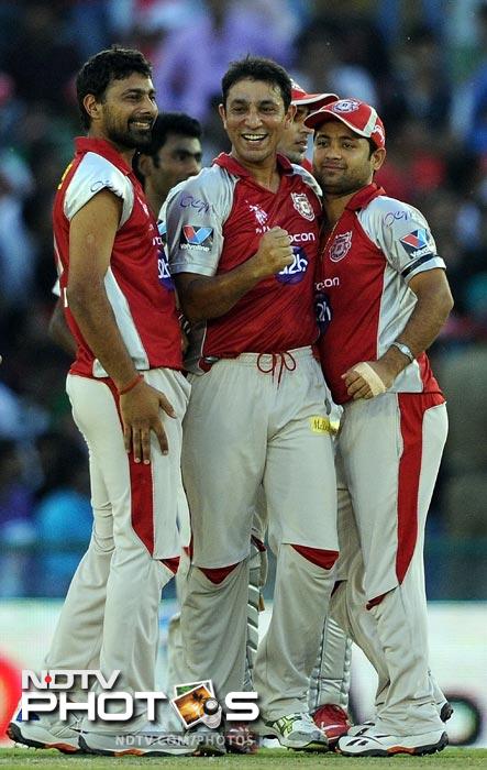 Azhar Mahmood celebrates the wicket of Sachin Tendulkar with teammates during the IPL Twenty20 match between Kings XI Punjab and Mumbai Indians at PCA Stadium in Mohali. (AFP Photo) IPL 5: Mumbai beat Punjab by 4 wickets