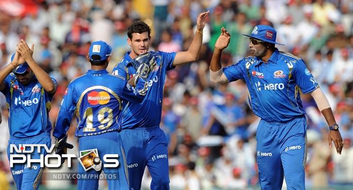 Clint McKay celebrates the wicket of Nitin Saini with teammates during the IPL Twenty20 match between Kings XI Punjab and Mumbai Indians at PCA Stadium in Mohali. (AFP Photo) IPL 5: Mumbai beat Punjab by 4 wickets