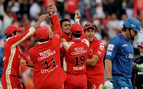 Anil Kumble of Royal Challengers Bangalore celebrates with teammates after taking the wicket of Adam Gilchrist (R) of Deccan Chargers during their IPL Twenty20 final match at The Wanderers Cricket Stadium in Johannesburg on May 24, 2009. (AFP Photo) IPL Final: HYD vs BLR