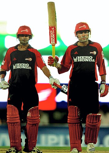 Delhi Daredevils' skipper Virender Sehwag gets a pat from partner Gautam Gambhir as he raises the bat after his fifty against Chennai Super Kings during the IPL T20 championship match at MAC Stadium in Chennai on Friday. (PTI Photo) 20th Match: Daredevils vs Super Kings