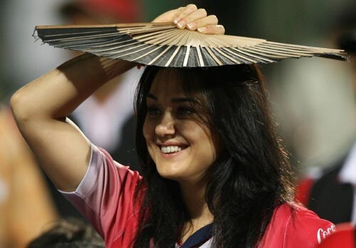 Preity Zinta of the Kings XI franchise used this fan as an umbrella as it rained at the Kotla. — <i>PTI Photo</i> 40th Match: Delhi Daredevils vs Kings XI Punjab