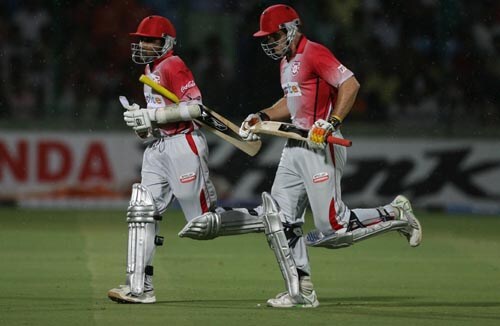Mahela Jayawardene and Luke Pomersbach run off the turf after another rain interruption. Kings XI won the game by six runs under the Duckworth/Lewis method. — <i>PTI Photo</i> 40th Match: Delhi Daredevils vs Kings XI Punjab