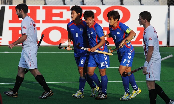 South Korean hockey player You Hyo Sik (C) celebrates with teammates after scoring a goal against Canada during their World Cup 2010 match at the Major Dhyan Chand Stadium in New Delhi. (AFP Photo) South Korea beat Canada