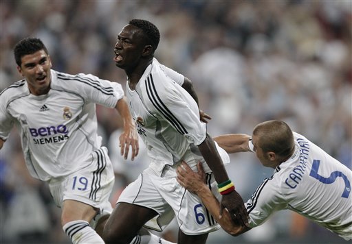 Real Madrid player Mahamadou Diarra, center, celebrates his goal with his teammates Fabio Cannavaro, right, and Jose Antonio Reyes during his Spanish League soccer match against Mallorca in Madrid. Real Madrid win La Liga
