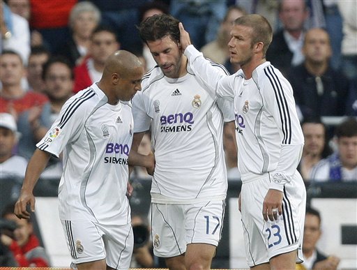 Real Madrid player Ruud Van Nistelrooy, center, gets comforted by his teammates David Beckham, right, and Roberto Carlos during the Spanish League soccer match against Mallorca in Madrid. Real Madrid win La Liga