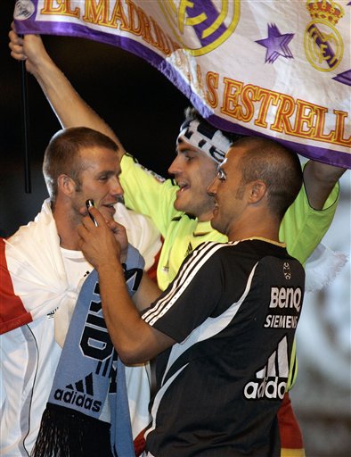 Real Madrid players David Beckham from England, left, Iker Casillas from Spain, center and Fabio Cannavaro from Italy, right, celebrate on their bus at Cibeles square after winning Spanish soccer league title in Madrid. Real Madrid win La Liga