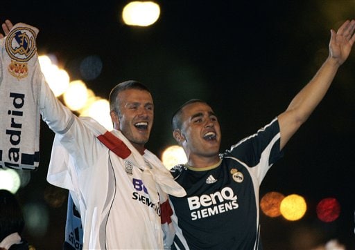 Real Madrid players David Beckham from England, left, and Fabio Cannavaro from Italy, right, celebrate on their bus at Cibeles square after winning Spanish league soccer title in Madrid. Real Madrid win La Liga
