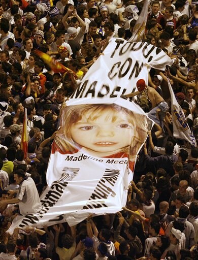 Real Madrid supporters display a banner reading "all with Madeline," a British girl who disappeared on May 3 in Portugal as they celebrate at Cibeles square that Real Madrid soccer team won the Spanish league title in Madrid. Real Madrid win La Liga
