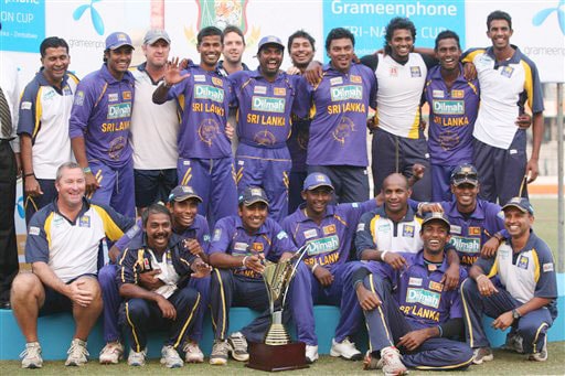 Sri Lankan team members pose with the trophy after their victory over Bangladesh at the end of the final match of the triangular one-day series in Dhaka. Sri Lanka win tri-series final