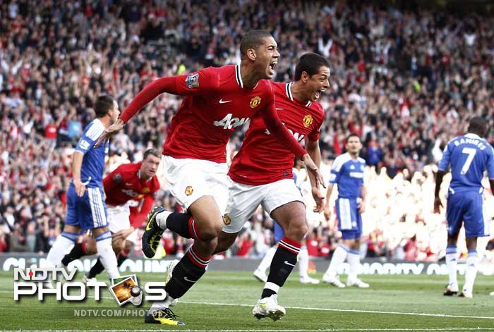 Chris Smalling, left, celebrates with teammate Javier Hernandez after scoring a goal against Chelsea during their English Premier League soccer match at Old Trafford. (AP Photo) Manchester United thrash Chelsea 3-1