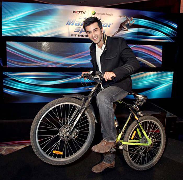 Campaign Ambassador Ranbir Kapoor enters on his bicycle.