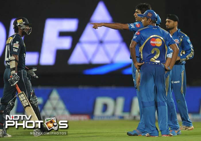 Skipper Kumar Sangakkara (l) was back for Deccan but his innings ended in a controversy when the Mumbai players challenged the decision that gave the Sri Lankan a lifeline.(AFP PHOTO / Noah SEELAM) IPL 5: Mumbai defeat Deccan in a thriller