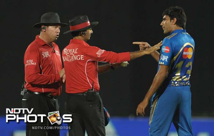 The ball had kissed the bails but it appeared to have hit the stumps on the rebound from wicket-keeper Dinesh Karthik's pads. Munaf, the bowler, appeared livid until the TV umpire was called into action and the verdict was reversed. (AFP PHOTO / Noah SEELAM) IPL 5: Mumbai defeat Deccan in a thriller