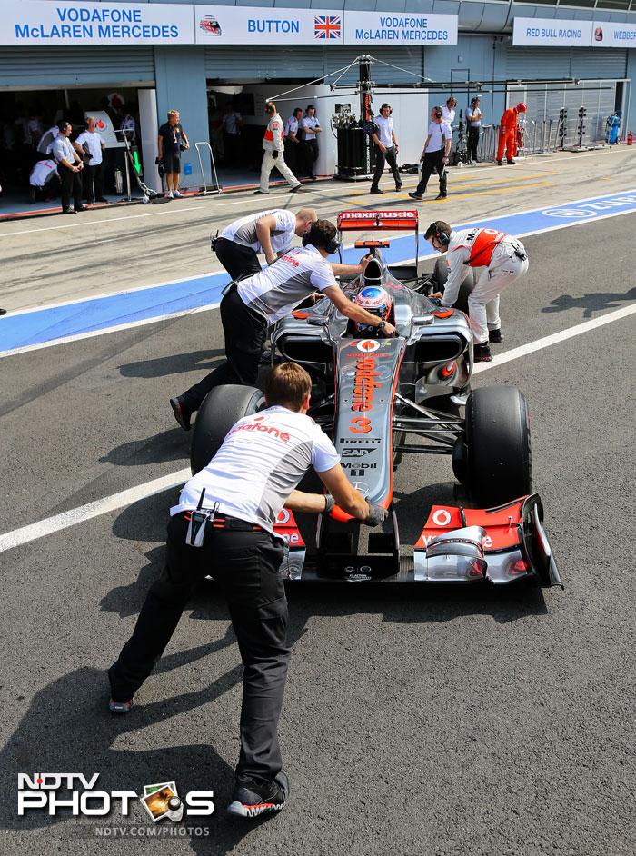 Mechanics push the car of McLaren Mercedes' British driver Jenson Button in the pits at the Autodromo Nazionale circuit, Monza (Italy). Italian Grand Prix: Qualifying session, Hamilton grabs pole