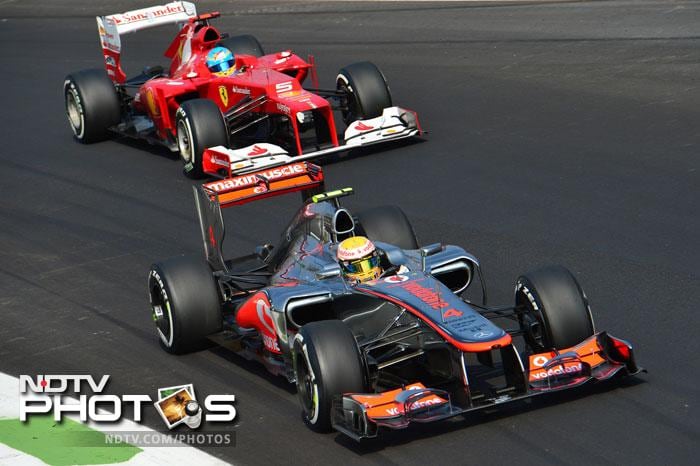 McLaren Mercedes' British driver Lewis Hamilton overtakes Ferrari's Spanish driver Fernando Alonso during the qualifying session at the Autodromo Nazionale circuit. Italian Grand Prix: Qualifying session, Hamilton grabs pole