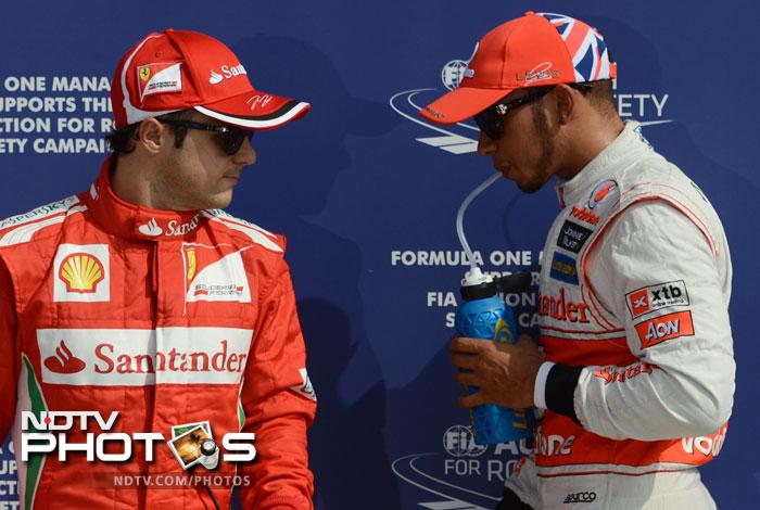 British driver Lewis Hamilton and Ferrari's Brazilian driver Felipe Massa arrive in the parc ferme at the Autodromo Nazionale circuit Italian Grand Prix: Qualifying session, Hamilton grabs pole