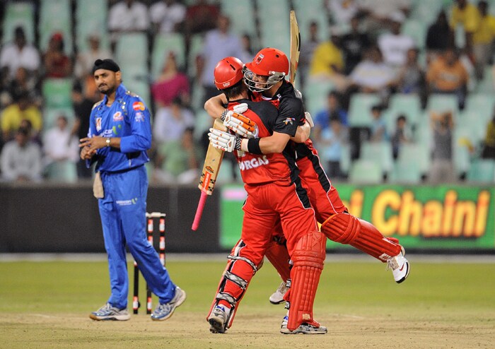 South Australian Redbacks batsmen Cameron Borgas and Tom Cooper celebrate after their victory over Mumbai Indians squad during the Champions League Twenty20 League match between the Mumbai Indians and the South Australian Redbacks at the Kingsmead Stadium in Durban. (AFP Photo) CLT20: Mumbai vs Redbacks