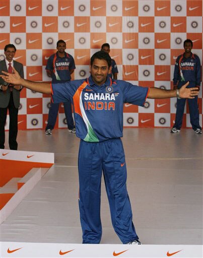 Indian captain Mahendra Singh Dhoni gestures as he displays the new apparel for the Indian one-day international team in Mumbai on Wednesday. (AP Photo) New jersey for Team India