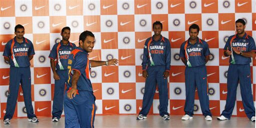 MS Dhoni displays the new apparel for the Indian one-day international team, as teammates, background from left, Zaheer Khan, Dinesh Karthik, Pragyan Ojha, Rohit Sharma and Yuvraj Singh look on, in Mumbai on Wednesday. (AP Photo) New jersey for Team India