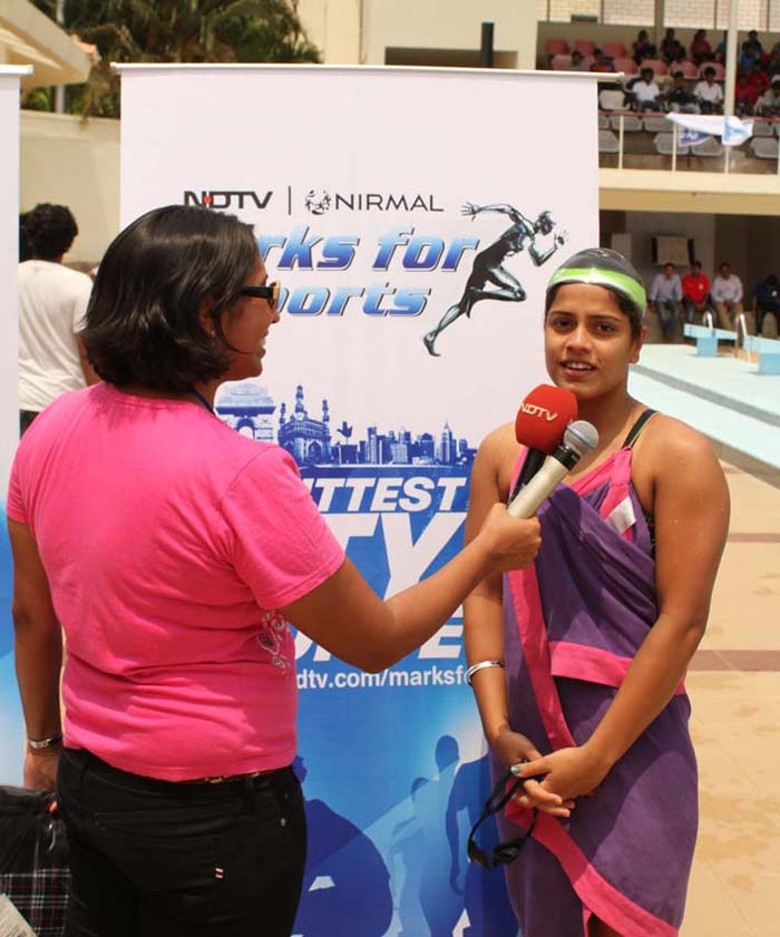 Nisha speaks to a budding swimmer about her effort and her plans for the future as swimming champ.